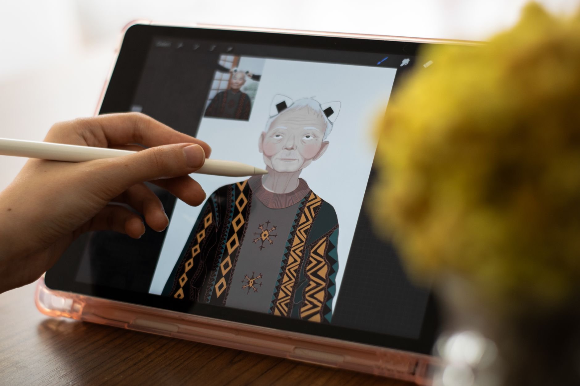 Close-up of hands using a tablet and stylus for digital art creation